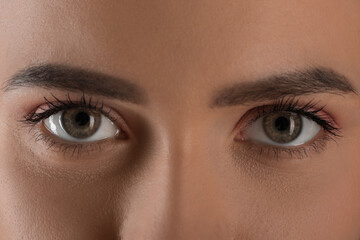 Fototapeta premium Evil eye. Young woman with scary eyes, closeup