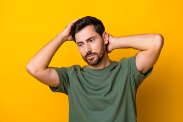 Fototapeta na wymiar Photo of positive cool guy dressed green t-shirt arms head enjoying haircare looking empty space isolated yellow color background