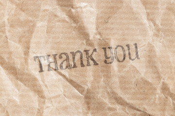 Thank you ink rubber stamp on crumpled brown paper