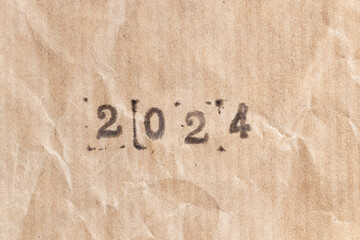 2024 ink rubber stamp on crumpled brown paper