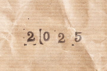 2025 ink rubber stamp on crumpled brown paper