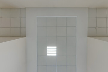 cassette stretched or suspended ceiling with square halogen spots lamps and drywall construction in empty room in house or office. Looking up view