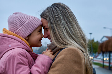 In candid pauses, the mother and daughter share hugs and kisses, creating cherished memories amid their walk.