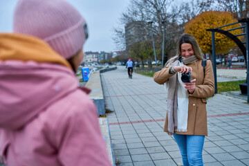 With a compact camera in hand, the mother captures the exuberance of her daughter on the quayside,...