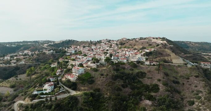 Pissouri Village from Above: A Spectacular Aerial View of Cyprus' Idyllic Mountain Village, Showcasing its Traditional Architecture, Red Tiled Roofs, and Scenic Landscape. High quality 4k footage