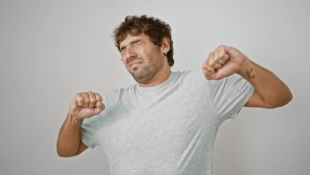 Casual, young, blond man in t-shirt yawning his morning boredom away. his sleepy eyes and tired yawn hinting at sleep deprivation. restless hand covering mouth, isolated on white background.
