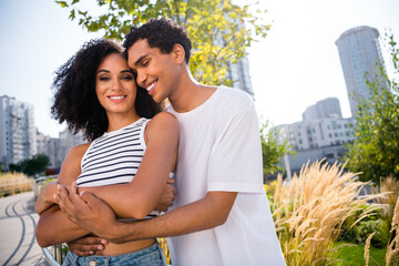 Photo of charming loving couple guy husband cuddle wife enjoy buying new flat in modern cityscape