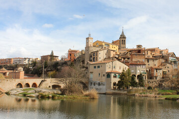 Fototapeta na wymiar Medieval town rising next to the river