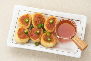 Gohyong or Ngo Hiang, made from minced chicken with flour, served with sour sauce
