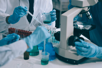 Scientist works with a pipette and a test tube. Scientific laboratory of biotechnology, development of medicine and research in chemistry, biochemistry and experiments.