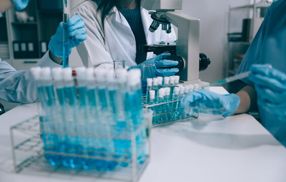Scientist works with a pipette and a test tube. Scientific laboratory of biotechnology, development of medicine and research in chemistry, biochemistry and experiments.