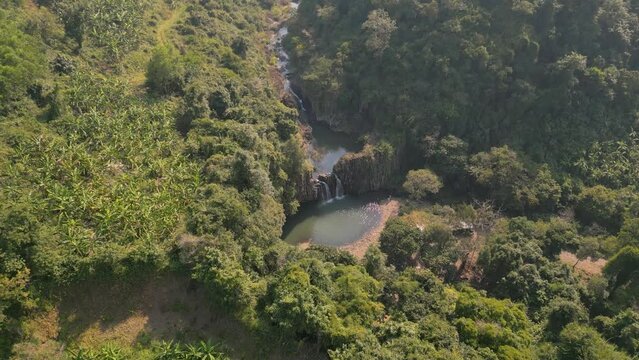 Stunning Vuc Hom Waterfalls nestled in pristine tropical setting surrounded by rainforest in Vietnam's Phu Yen province