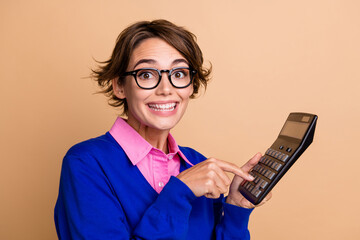 Photo portrait of pretty young girl hold excited calculator dressed stylish blue outfit isolated on...