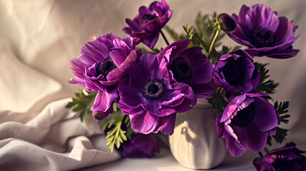 A striking arrangement of deep purple anemones, their bold colors and delicate structure captured in vivid 4K HDR, set in a simple vase on a light, neutral surface.