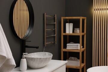 Fototapeta na wymiar Stylish bathroom interior with heated towel rail and modern furniture