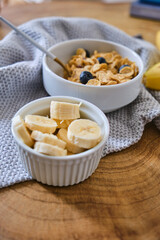 Smoothie bowl with banana, blackberries and muesli on wood table. Healthy eating, healthy lifestyle