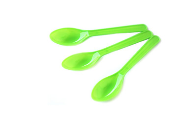 Green plastic disposable spoons isolated on white background. Concept, equipment for eating utensil, can be reuse or recycle to made DIY craft.      