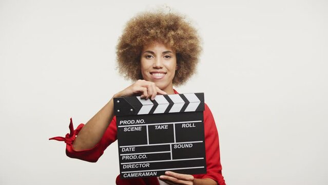 Smiling Woman with Clapperboard on White Background