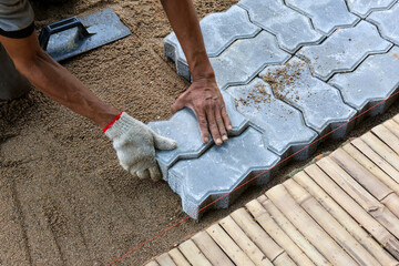 selective focus Interlocking Paver Tile modern bricks are meticulously prepared on the floor by craftsmen.