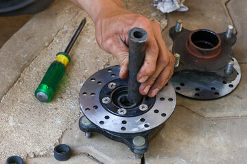 Selective focus Motorcycle disc brake disc was removed and set to be repaired by replacing wheel...