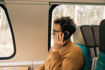 Woman talking on the phone on her train ride