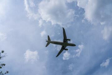 Fototapeta na wymiar Underside view of airplane taking off