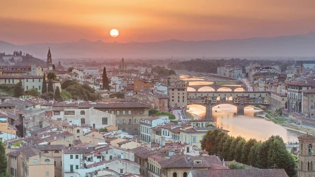 Skyline view of Arno River aerial timelapse from above. Ponte Vecchio from Piazzale Michelangelo at Sunset, Florence, Italy. Colorful sky. Evening mist
