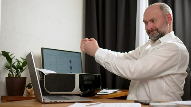 Stressed angry businessman smashing his printer with hands, job burnout concept. Broken office print equipment. Agitated man pounds fists on multifunction printer after business setbacks. Professional