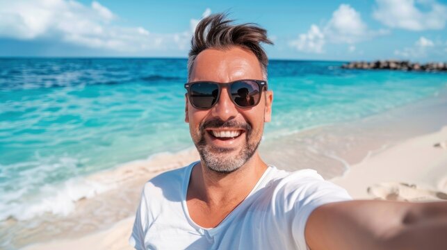 happy handsome man taking selfie pic with cellphone at the beach in a summer day