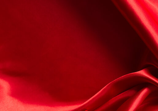 The bright red silk satin surface is beautiful and luxurious, wavy. For background and graphic work Blurry or blurry