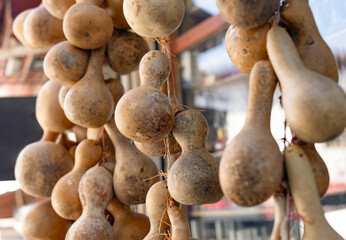 Dry calabash gourds hung in a shop at bazaar. - obrazy, fototapety, plakaty