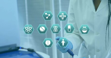 Animation of hexagonal medical icons over african american female scientist at work in lab - Powered by Adobe