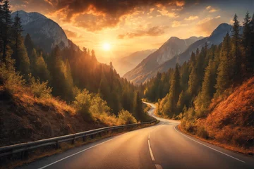 Gordijnen A beautiful scenic road among mountains and forests on the background of sunset. The road to sunset. The natural beauty of the planet © borisenkoket