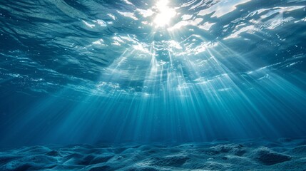 Underwater view with sunbeams shining through the ocean's surface, creating a serene and ethereal blue world.