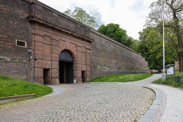 city wall with tunnel and walking path and trees