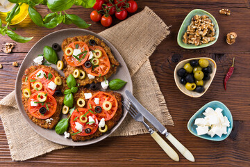 Breaded pork chop in tomatoes. Served with olives and feta cheese.