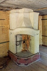 Interior view of old traditional brick oven heated by wood with walls covered with newspaper.