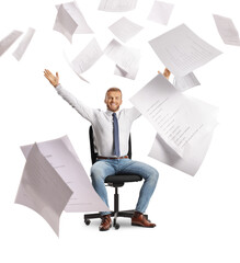 Happy man sitting in an office chair and throwing papers