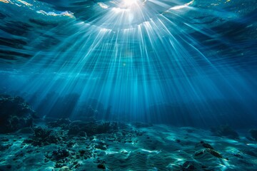 Underwater view with sunbeams shining through the ocean surface
