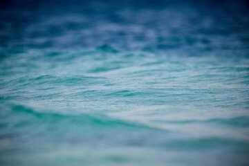 Egypt - close-up of a wave in the red sea with selective focus and different shades of blue