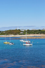 Fototapeta na wymiar Isles of Scilly, United Kingdom - sailboats anchoring at Porthcressa Beach with Hugh Town in the background