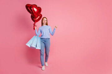 Full body photo of cheerful woman hold bubbles new clothes in bags indicating at proposition empty...
