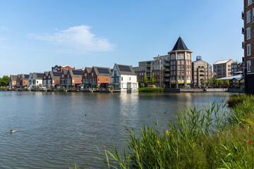 Utrecht, the Netherlands. 5 June 2023. Center Vleuterweide Utrecht with shops and houses equipped with solar panels. with a lake in front