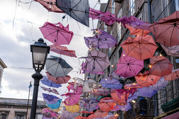 A colorful display of umbrellas hanging from the ceiling
