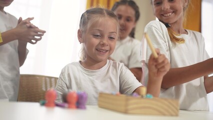 child group playing fishing lifestyle. children in kindergarten play with toys. happy family kid dream concept. a group of children collect building blocks in a kindergarten indoors