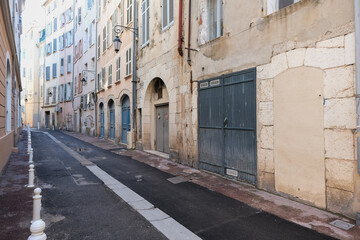 Romantic backstreet road alley in historic old town downtown Toulon, France with Mediterranean...