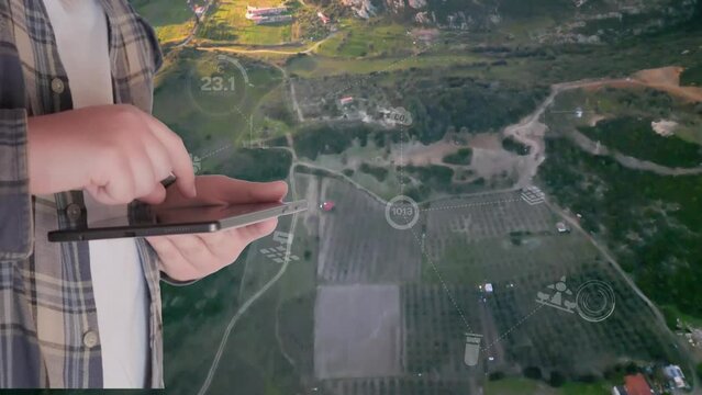 POV of a farmer using digital tablet in the vegetable farm, organic smart farm control by science technology and visual graphic display.