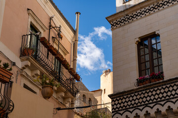 Fototapeta na wymiar Two buildings with balconies and a cloudy sky