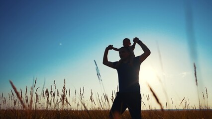 father and son in the park. father's day silhouette happy family child dream concept. father...