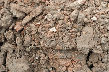 The texture of clumps of clay soil. Plowed land in close-up. Mining of minerals.